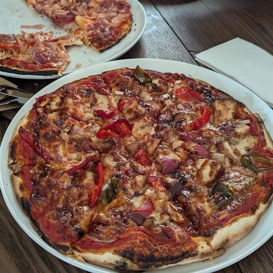 Wood-fired pizza on a board