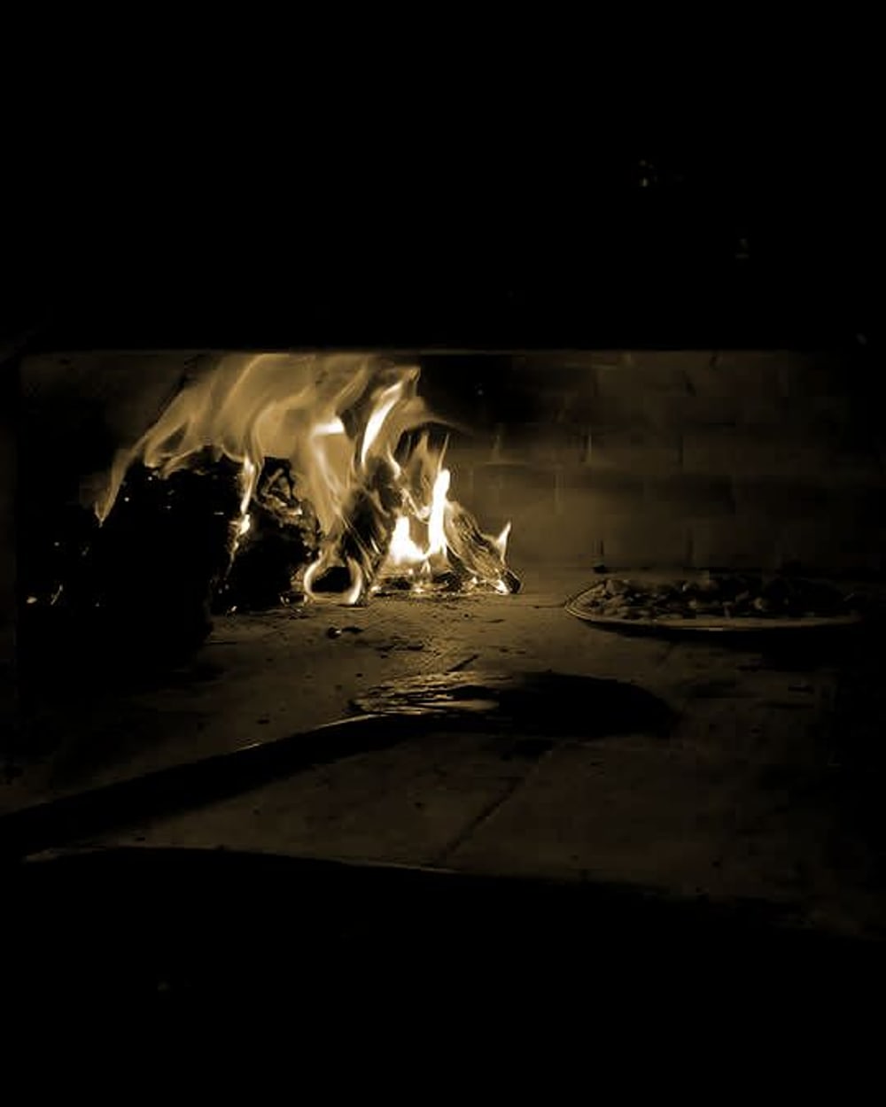 The wood-fired oven at Ciao Baby, flames going