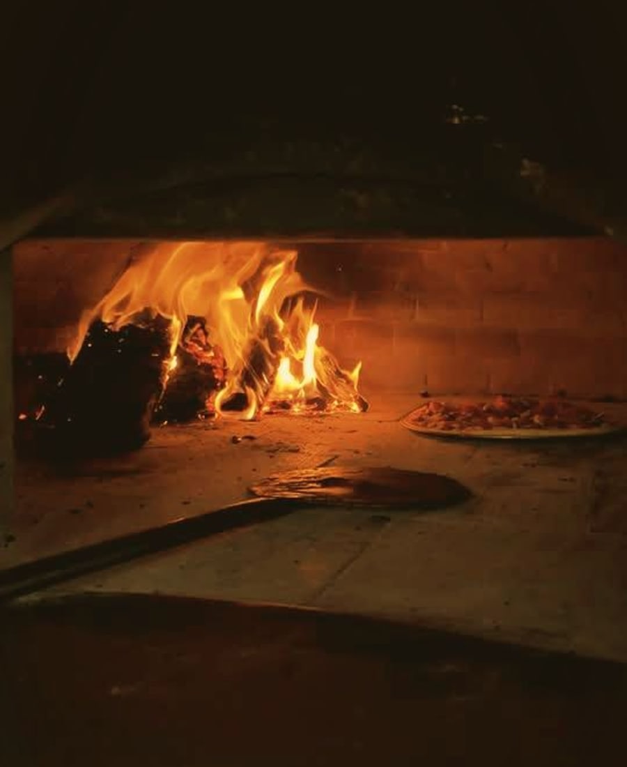The wood-fired oven at Ciao Baby, flames going